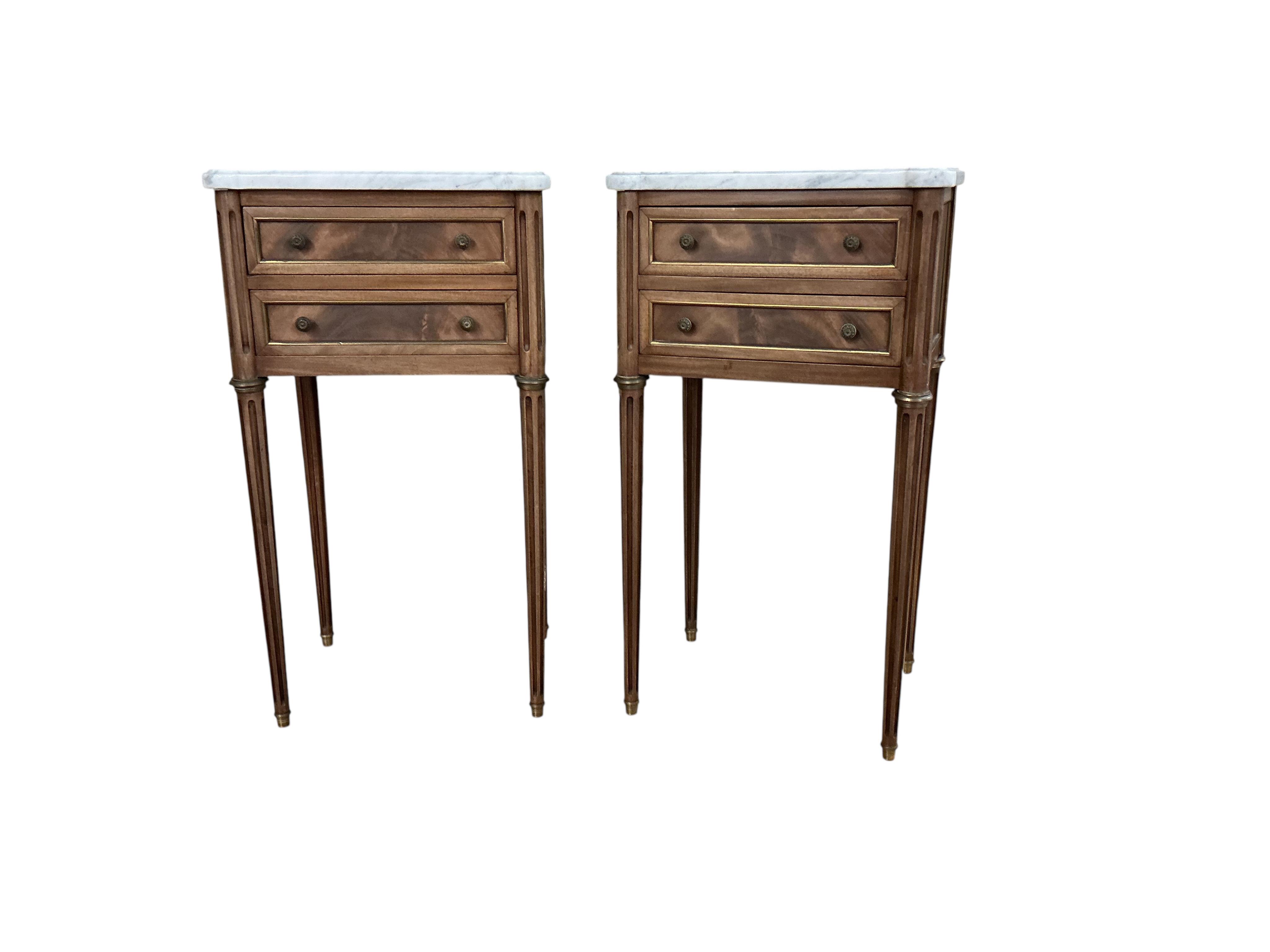 A pair of French brass mounted mahogany marble topped two drawer bedside chests, width 38cm, depth 30cm, height 68cm